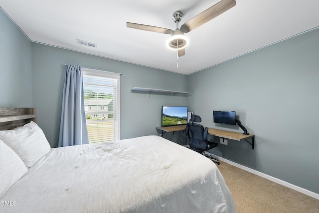 carpeted bedroom featuring visible vents, a ceiling fan, and baseboards