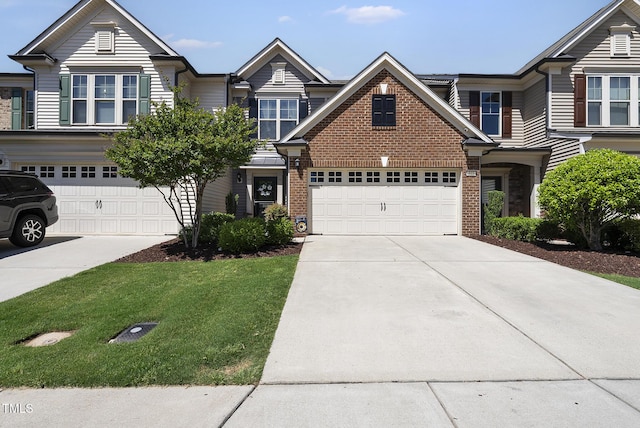 view of front of home featuring brick siding, a front lawn, and driveway