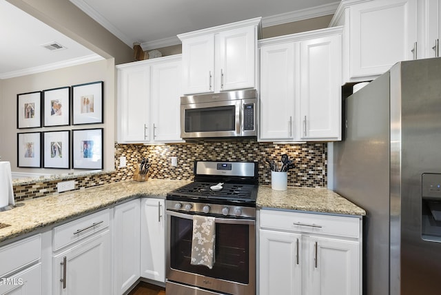 kitchen featuring decorative backsplash, ornamental molding, white cabinetry, light stone counters, and appliances with stainless steel finishes