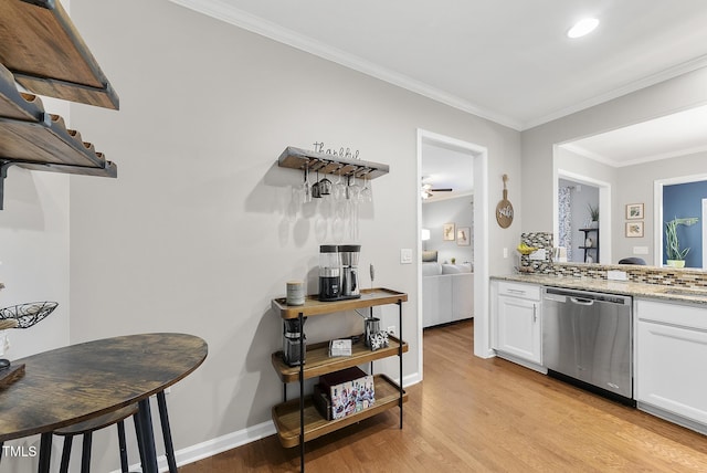 kitchen with crown molding, light stone countertops, dishwasher, white cabinets, and light wood-style flooring