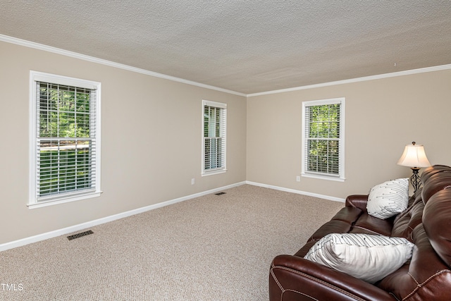 living area with crown molding, baseboards, and visible vents
