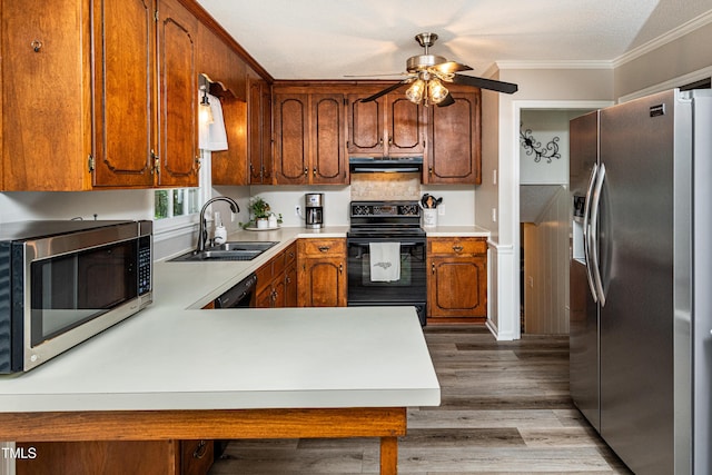 kitchen featuring crown molding, a sink, extractor fan, a ceiling fan, and black appliances