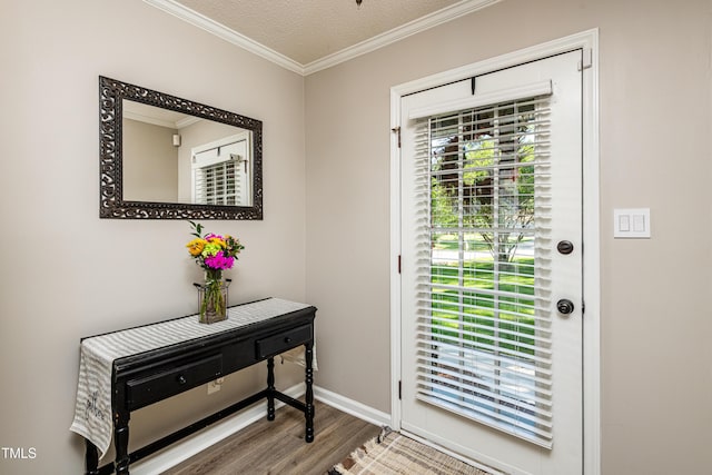 doorway featuring baseboards, ornamental molding, and wood finished floors