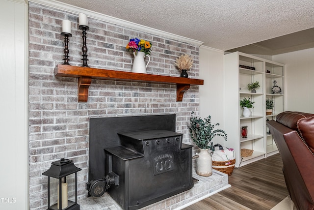 living room featuring crown molding, a textured ceiling, and wood finished floors