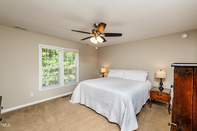 bedroom with carpet floors, a ceiling fan, baseboards, and visible vents