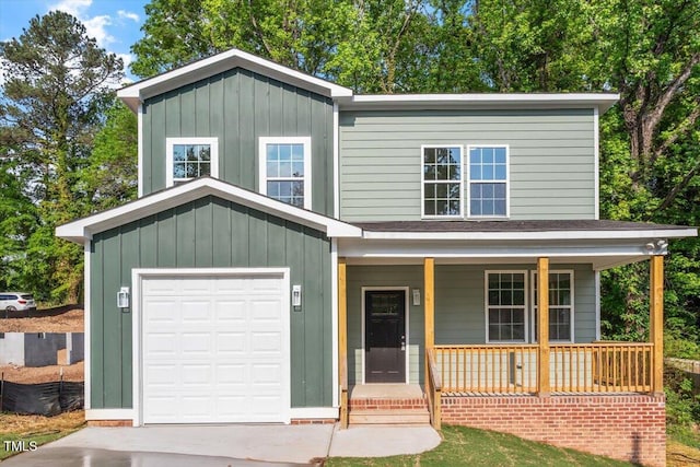 view of front facade with covered porch, board and batten siding, and driveway