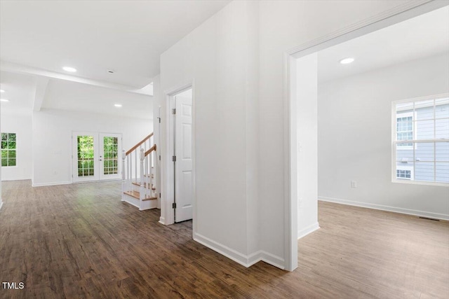 hall with visible vents, wood finished floors, baseboards, stairway, and recessed lighting