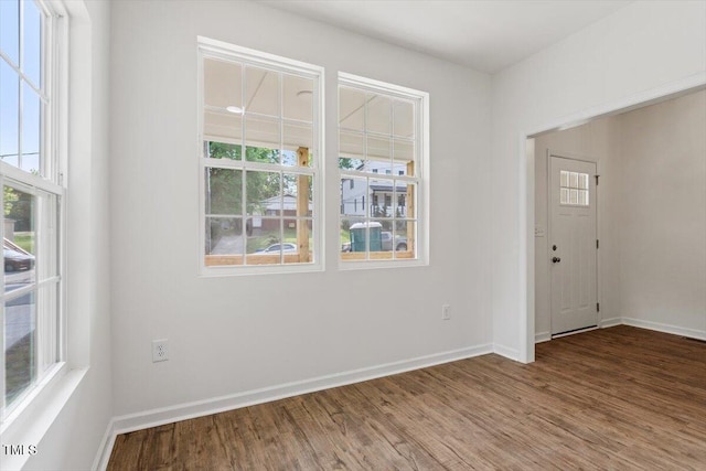 empty room featuring baseboards and wood finished floors