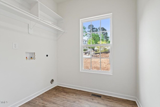 laundry area featuring laundry area, washer hookup, baseboards, hookup for an electric dryer, and visible vents
