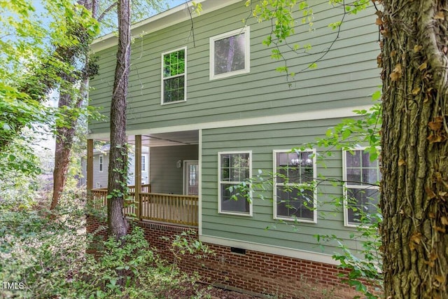 back of house featuring covered porch