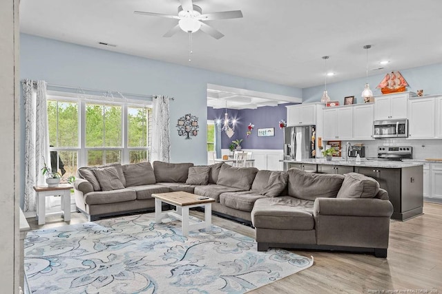 living area with visible vents, a ceiling fan, light wood-style floors, and recessed lighting