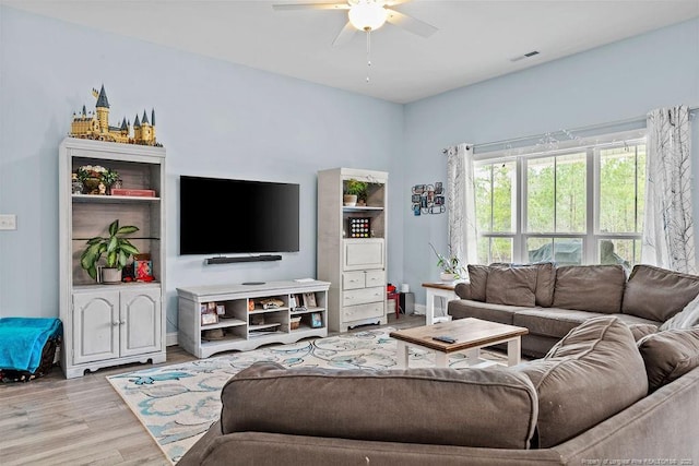 living area featuring visible vents, ceiling fan, and wood finished floors
