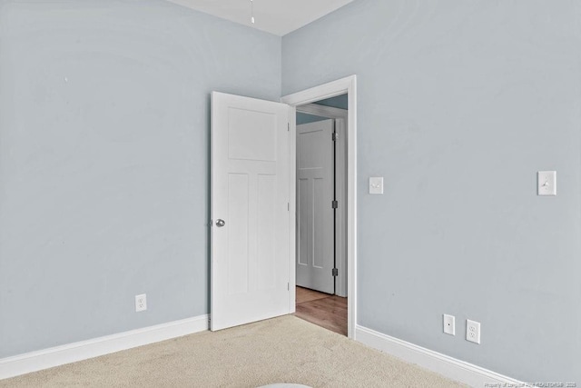 carpeted empty room with baseboards