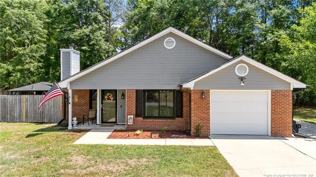 single story home with fence, a front lawn, brick siding, a garage, and concrete driveway
