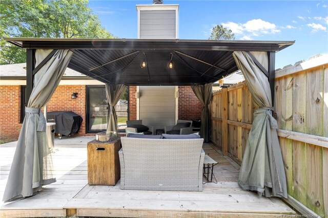 exterior space with area for grilling, a gazebo, fence, and outdoor lounge area