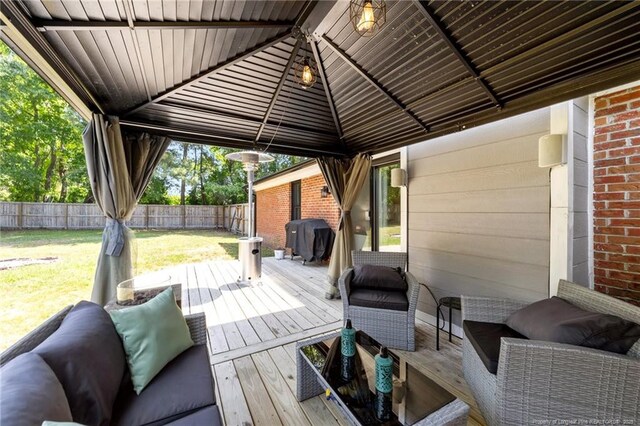 wooden terrace with a gazebo, fence, a yard, and a grill