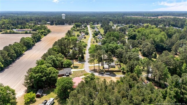 birds eye view of property featuring a wooded view