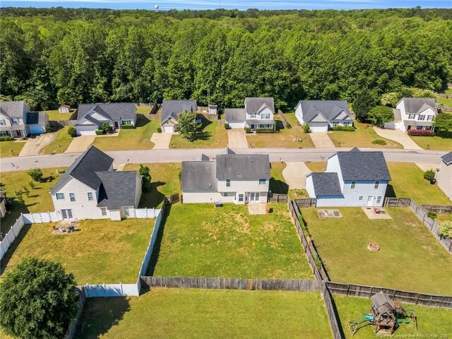 drone / aerial view featuring a view of trees and a residential view