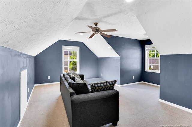bonus room with carpet floors, baseboards, a textured ceiling, a ceiling fan, and vaulted ceiling