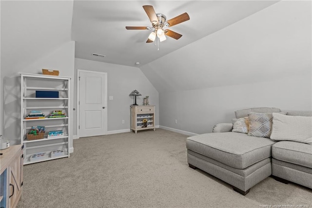 interior space featuring a ceiling fan, baseboards, light colored carpet, and vaulted ceiling