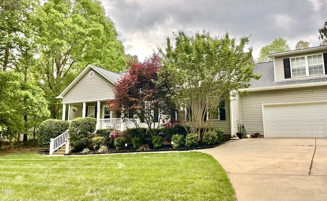view of front of home featuring covered porch, roof with shingles, driveway, and a front yard