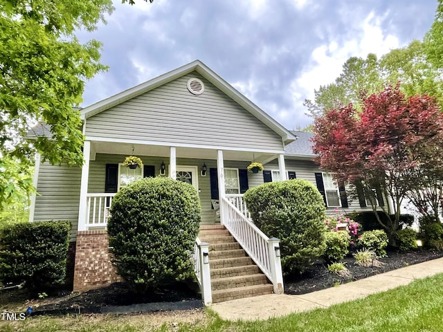 bungalow featuring a porch and stairway