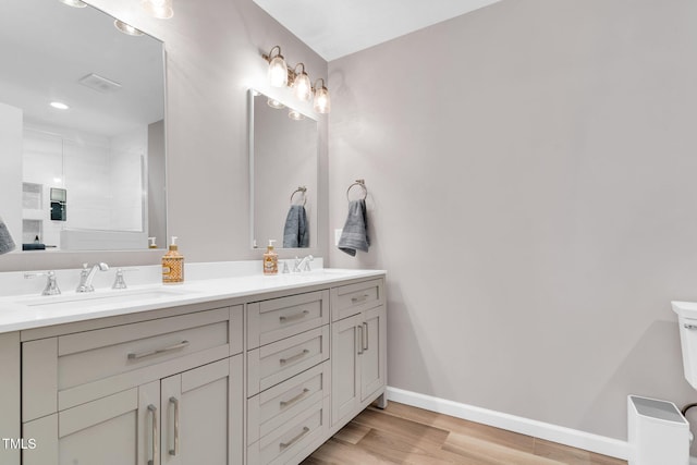76 Bergeson Ct, Fuquay Varina, NC 27526 - bathroom with wood finished floors, baseboards, a shower with shower door, and double vanity