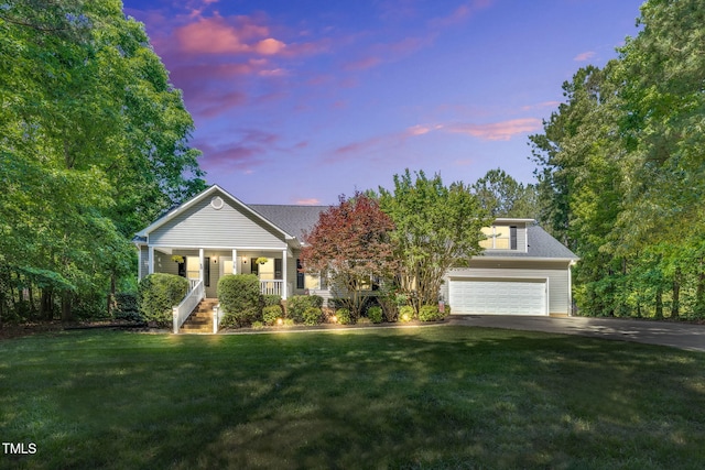 76 Bergeson Ct, Fuquay Varina, NC 27526 - view of front facade featuring driveway, covered porch, a yard, and a garage
