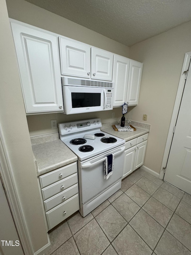 kitchen featuring white appliances, white cabinetry, light tile patterned floors, and light countertops