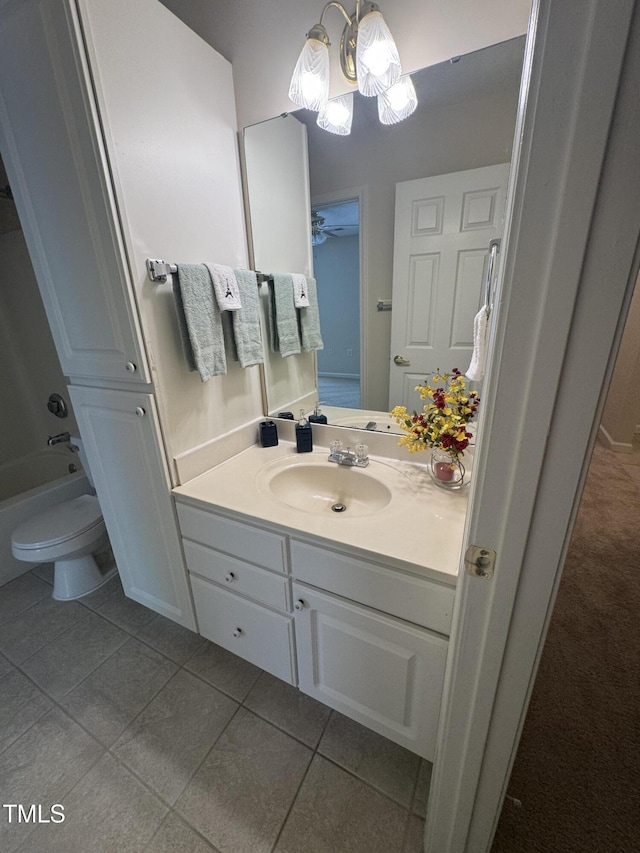 full bath featuring vanity, bathing tub / shower combination, toilet, tile patterned floors, and a notable chandelier