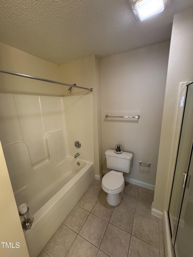 full bathroom with toilet, a textured ceiling, tile patterned floors, baseboards, and  shower combination