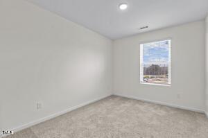 empty room featuring carpet floors and baseboards