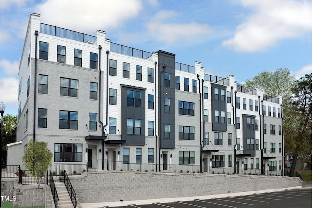 view of building exterior with uncovered parking