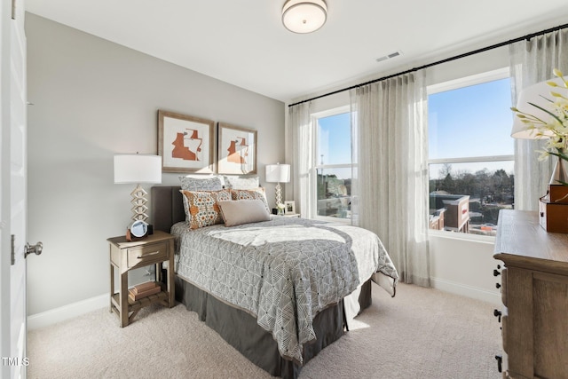 bedroom with carpet floors, baseboards, and visible vents
