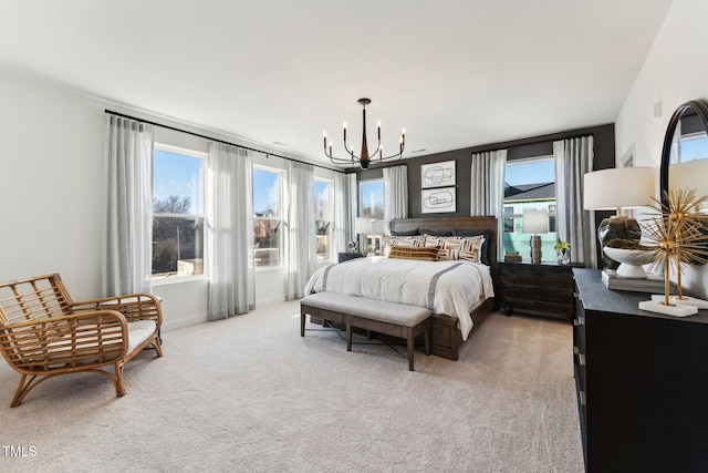 bedroom featuring a chandelier and light carpet