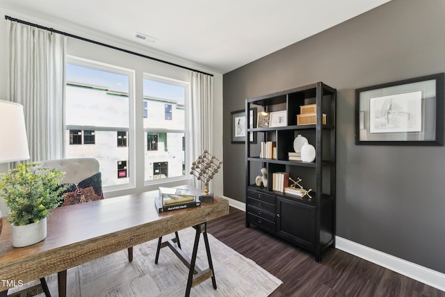 office area featuring dark wood-type flooring, baseboards, and visible vents