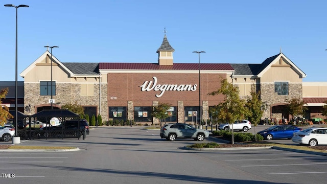 view of building exterior featuring uncovered parking