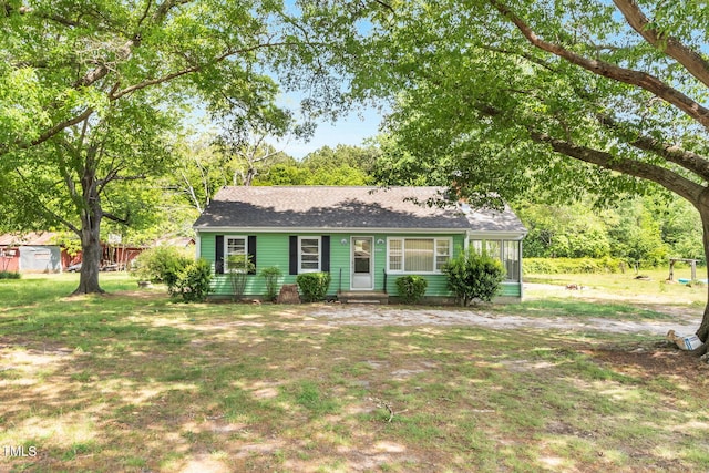 2677 NC-39, Henderson, NC 27537 - view of front of property with a sunroom, entry steps, a front yard, and roof with shingles
