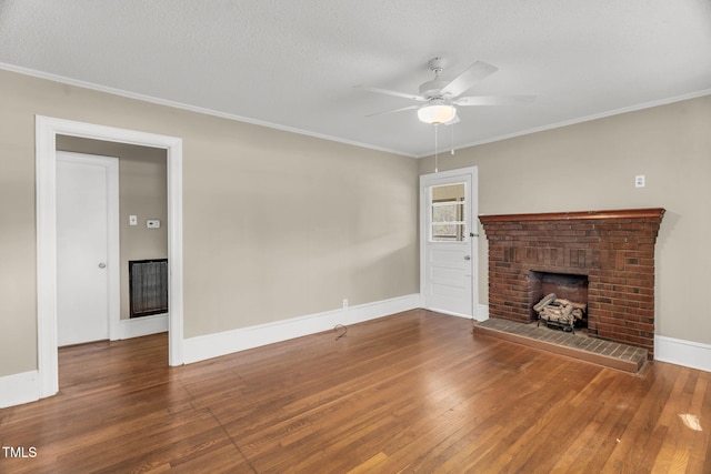 2677 NC-39, Henderson, NC 27537 - unfurnished living room with crown molding, hardwood / wood-style floors, a fireplace, baseboards, and a ceiling fan