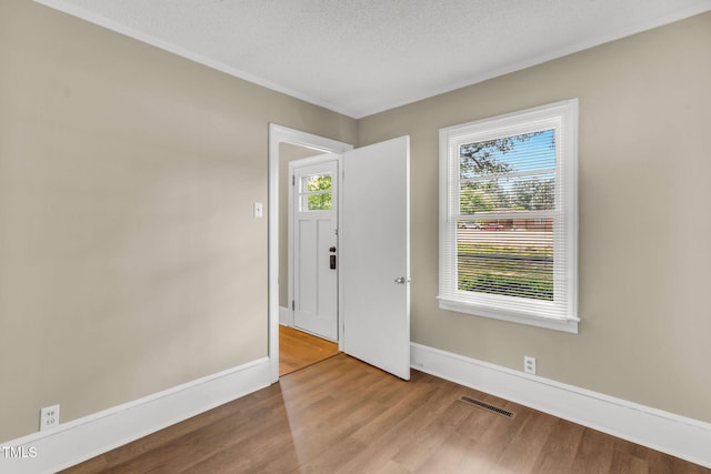 2677 NC-39, Henderson, NC 27537 - entryway featuring a textured ceiling, baseboards, wood finished floors, and visible vents