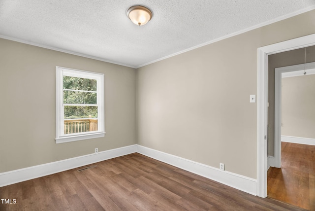 2677 NC-39, Henderson, NC 27537 - empty room with a textured ceiling, baseboards, dark wood-type flooring, visible vents, and ornamental molding