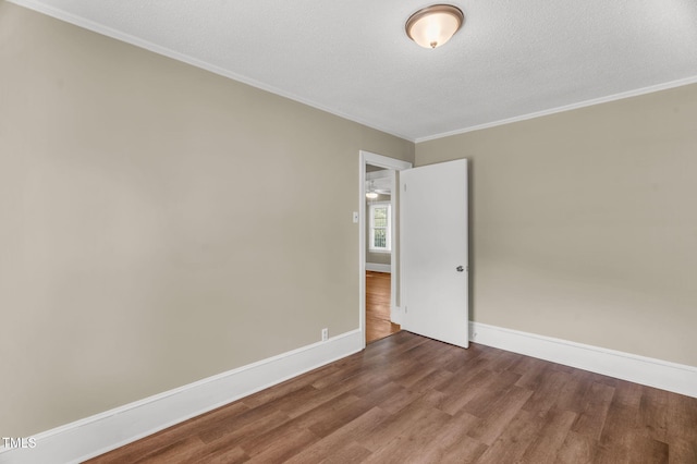 2677 NC-39, Henderson, NC 27537 - spare room with baseboards, a textured ceiling, crown molding, and wood finished floors