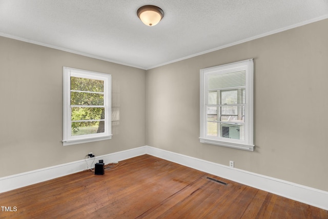 2677 NC-39, Henderson, NC 27537 - spare room with a textured ceiling, baseboards, wood finished floors, visible vents, and ornamental molding