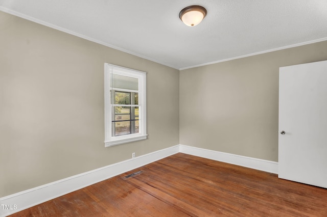 2677 NC-39, Henderson, NC 27537 - spare room with baseboards, visible vents, ornamental molding, and wood finished floors