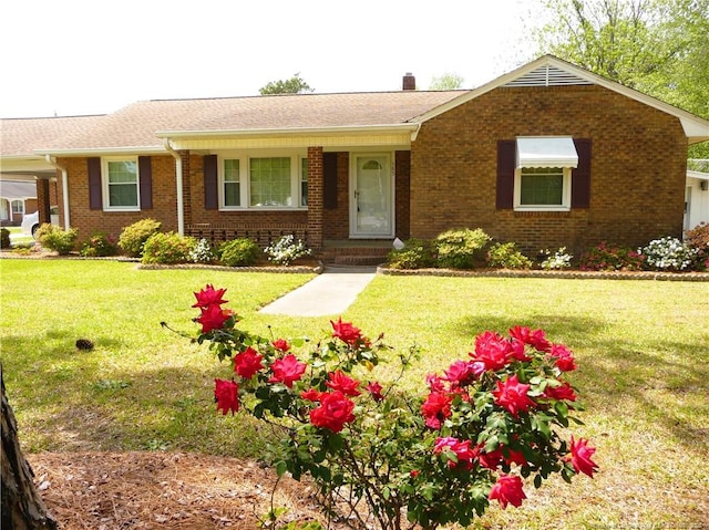 185 Meadow Rd, Lumberton, NC 28358 - ranch-style home with brick siding, a chimney, roof with shingles, and a front lawn