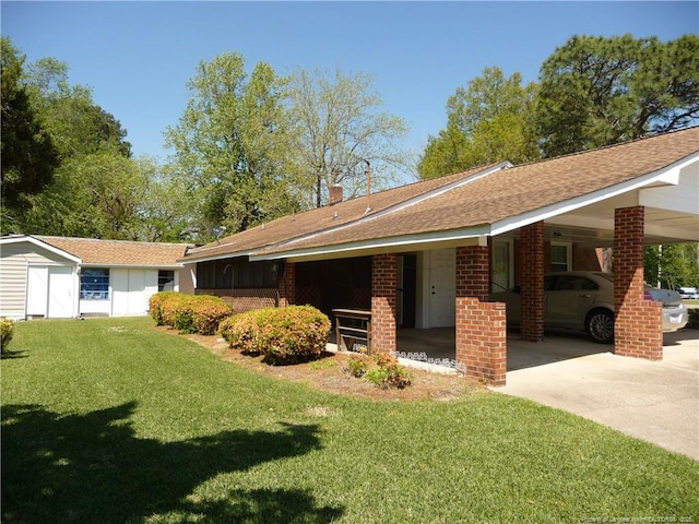 185 Meadow Rd, Lumberton, NC 28358 - exterior space featuring a lawn, a shingled roof, brick siding, and an attached carport