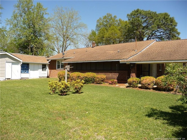 185 Meadow Rd, Lumberton, NC 28358 - view of front of home featuring brick siding, a front lawn, roof with shingles, and a chimney