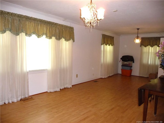 185 Meadow Rd, Lumberton, NC 28358 - living area with an inviting chandelier, light wood finished floors, baseboards, visible vents, and ornamental molding