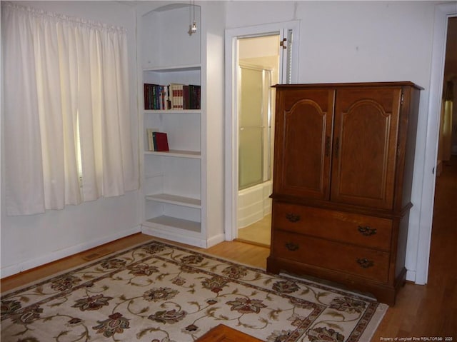 185 Meadow Rd, Lumberton, NC 28358 - unfurnished bedroom featuring light wood-style floors, connected bathroom, and baseboards