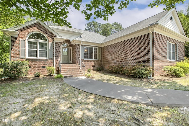 ranch-style house featuring brick siding